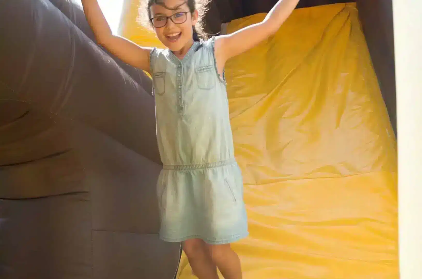 Child having fun in the campsite's inflatable structure